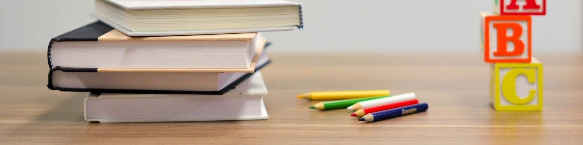 Books and school supplies on light wood-look flooring